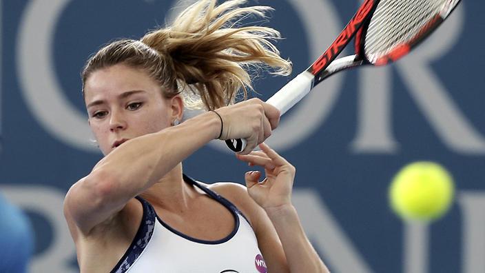 Camila Giorgi of Italy plays a shot in her first round match against Angelique Kerber of Germany during the Brisbane International tennis tournament in Brisbane, Australia, Monday, Jan. 4, 2016. (AP Photo/Tertius Pickard)